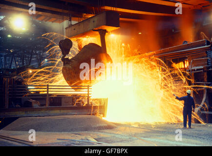 smelter, smelting iron ore, adding molten pig iron from blast furnace Stock Photo