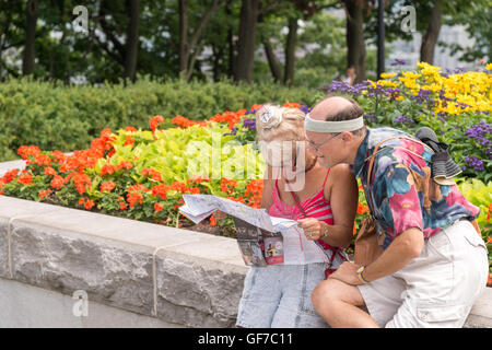 Couple looking at a map on Mont Royal's belvedere in Montreal, Canada Stock Photo