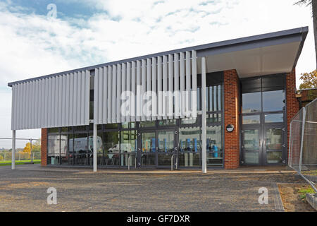 fixed vertical louvres provide sun shade for a large, south-facing window on a new school dining hall in Southern England Stock Photo