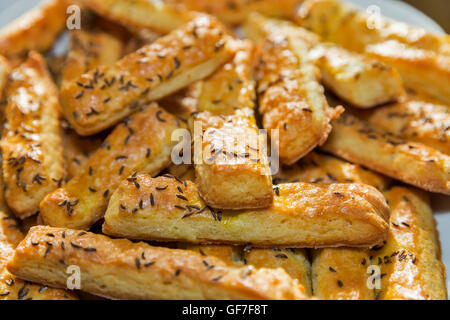 fresh baked puff cheese sticks with caraway seeds closeup Stock Photo