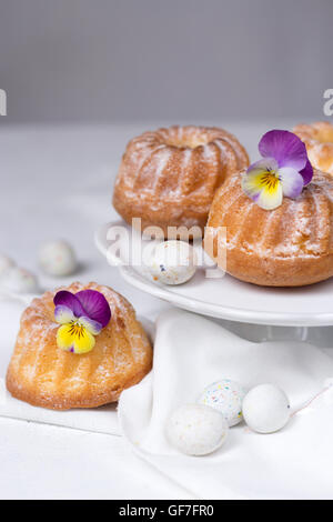 Easter cakes, pansies and eggs Stock Photo