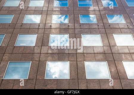 Clouds reflexions on a building with square windows in London Stock Photo