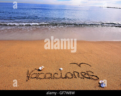 Vacation sign on the beach in spanish Stock Photo