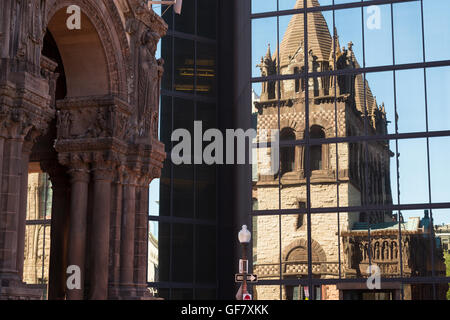 A photograph of the reflection of Trinity Church in the John Hancock Tower, in the City of Boston, Massachusetts. Stock Photo