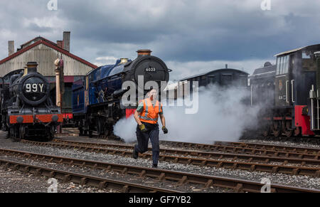 Volunteer at the Didcot Railway Centre ahead of restored King Edward II steam locomotive to ensure the train is filled with coal Stock Photo