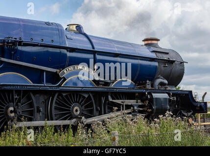 Restored King Edward II steam locomotive puffing steam on the rail tracks Stock Photo