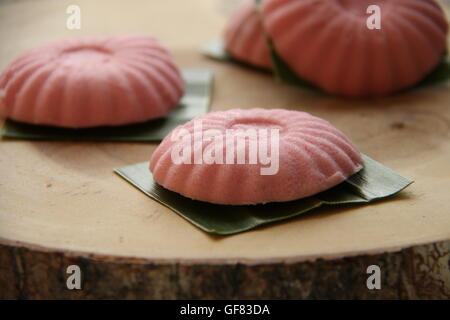 Tutu kueh with grated coconut filling; arranged on wooden block Stock Photo