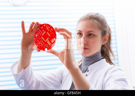 Tech tests electronic equipment in service center Stock Photo