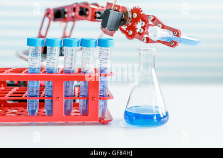 robot manipulates test tubes with dangerous chemicals Stock Photo