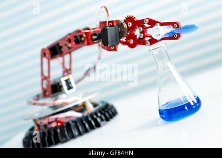 robot manipulates test tubes with dangerous chemicals Stock Photo