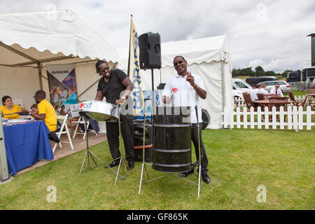 Two percussionists playing steel drums as part of the Barbados stand at the Jaeger Le Coultre Gold Cup final at Cowdray Park. Stock Photo