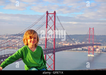 Smiling boy at the Golgen Gate bridge, Lisbon, Portugal Stock Photo