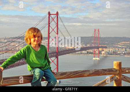 Smiling shaggy boy at the Golden bridge, Lisbon, Portugal Stock Photo