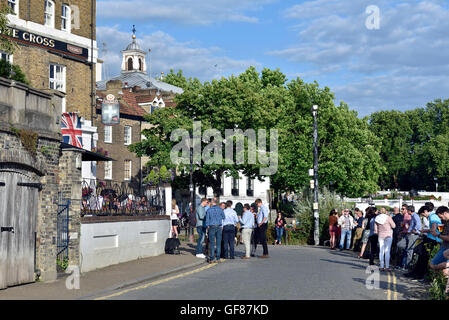 People drinking outside The White Cross pub Richmond Riverside Surrey England Britain UK Stock Photo