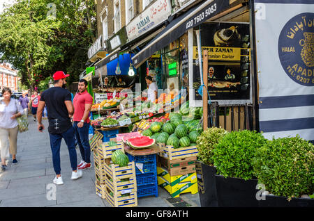 Fresh fruit and vegetables on display outside a shop on Kensington High Street, London. Stock Photo