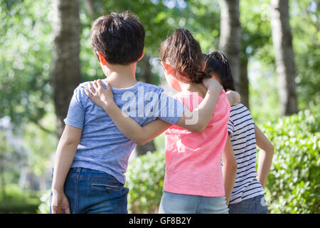 Happy Chinese children playing in woods Stock Photo