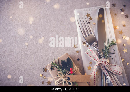 Christmas table place setting, holidays copy space fairy light toning background Stock Photo