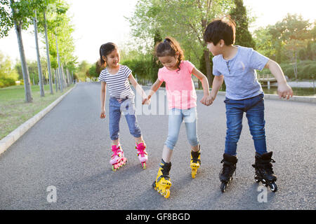 Happy Chinese children roller skating Stock Photo