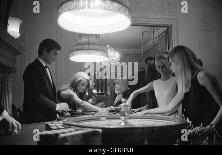 Charlotte Rampling and Joanna Pettit, gambling at The Pair of Shoes, a casino in London, 1966 Stock Photo
