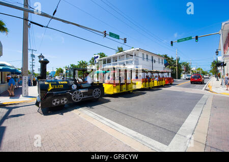KEY WEST, FLORIDA, USA - MAY 02, 2016: Tourists on the famous 'conch tour train' riding and sightseeing through Duval street in Stock Photo