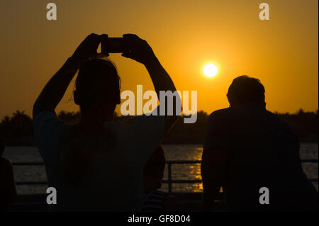 Tourists are making pictures of the sunset in Key West in Florida Stock Photo