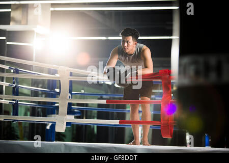 Chinese boxer resting in boxing ring Stock Photo