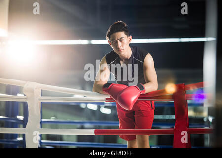 Chinese boxer resting in boxing ring Stock Photo