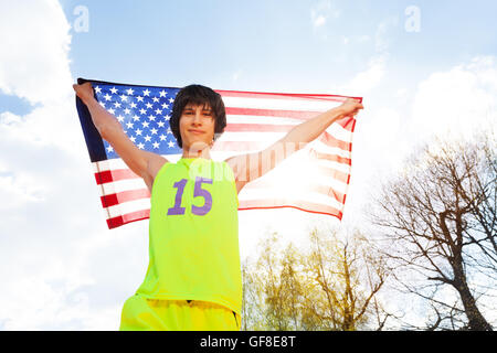 Portrait of teenage athlete holding American flag Stock Photo