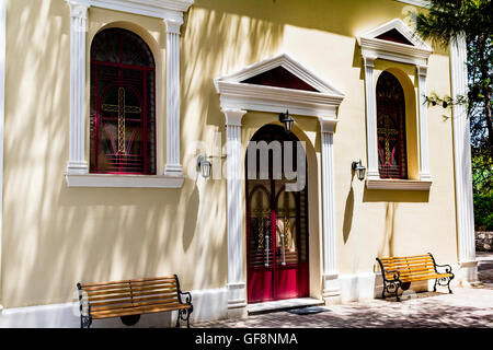 Red Doors at a Church on a Hill – Poros, Kefalonia, Greece. Stock Photo