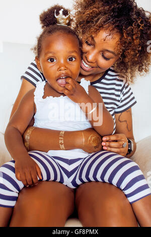 adorable sweet young afro-american mother with cute little daughter, hanging at home, having fun playing smiling, lifestyle people concept Stock Photo