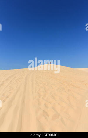 people in desert at white sand dune in mui ne , vietnam Stock Photo