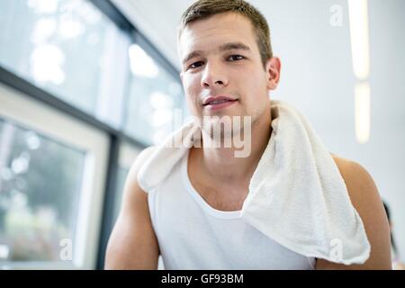 PROPERTY RELEASED. MODEL RELEASED. Portrait of young man with napkin around neck in gym, close-up. Stock Photo