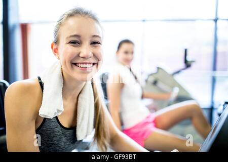 PROPERTY RELEASED. MODEL RELEASED. Portrait of young woman with napkin around her neck in gym, smiling. Stock Photo