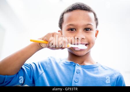 MODEL RELEASED. Boy brushing teeth, portrait, close-up. Stock Photo