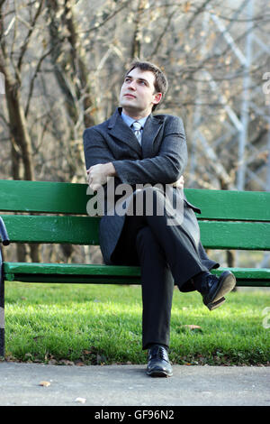 Young business man waiting for meeting at green park Stock Photo