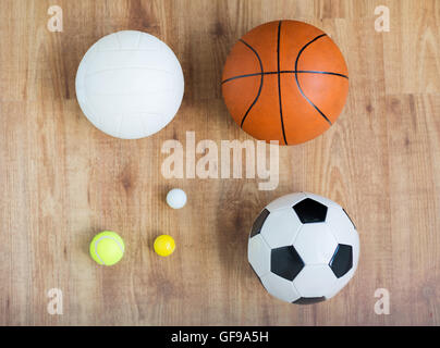 close up of different sports balls set on wood Stock Photo