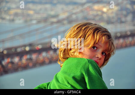 Pretty boy on abstract cityscape background Stock Photo