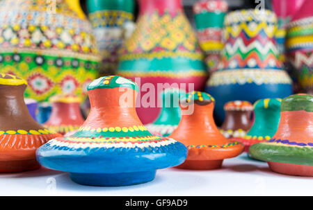 Still life of colorful pottery lids on blurred background of colored pottery vases Stock Photo