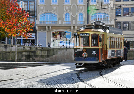 PORTO, PORTUGAL - NOVEMBER 26: Retro tram number 18 goes by the street of Porto historical centre on November 26, 2013. Porto is Stock Photo