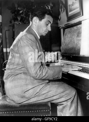 Irving Berlin playing the piano. Portrait of the American composer and lyricist, Irving Berlin (1888-1989) c.1948. Stock Photo