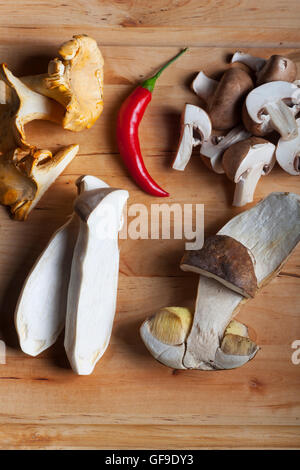 different edible mushrooms on wood Stock Photo