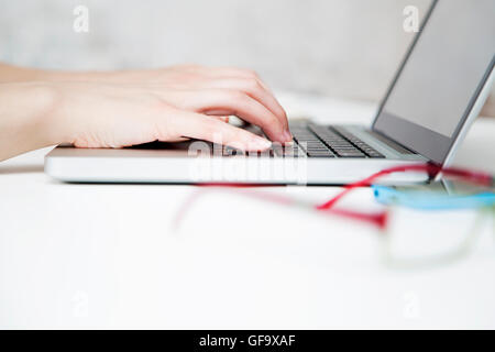 Closeup of business woman hand typing on laptop keyboard Stock Photo