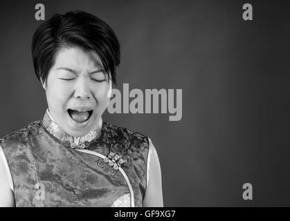 female model attractive woman on plain background with copy space screaming frustration Stock Photo