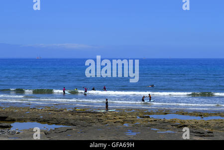 Surfing on Playa De Las Americas beach Stock Photo