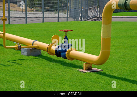 Image of main gas pipe valve overlap on a background of green grass Stock Photo