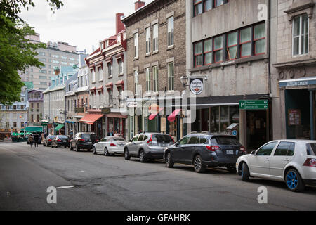 QUEBEC CITY - MAY 25, 2016: Rue St. Jean in old Quebec City is lined with quaint shops and restaurants which draw millions of to Stock Photo