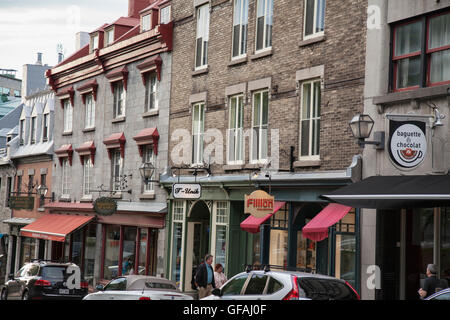 QUEBEC CITY - MAY 25, 2016: Rue St. Jean in old Quebec City is lined with quaint shops and restaurants which draw millions of to Stock Photo