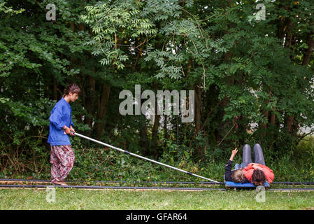 Charlton Park, UK. 30th July, 2016. Festival goers travel on Track, an immersive art installation by artist Graeme Miller at WOMAD Festival, 30 July 2016. © Adam Gasson/Alamy Live News Stock Photo