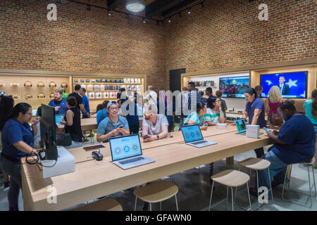 Apple enthusiasts descend on Williamsburg, Brooklyn in New York for the grand opening of Apple's first store in Brooklyn on Saturday, July 30, 2016. The tech company's new store features exposed brick, giant arch windows and at one story with a brick facade blends in with the neighborhood. Apple gave away commemorative tee-shirts to those attending the grand opening. (© Richard B. Levine) Stock Photo