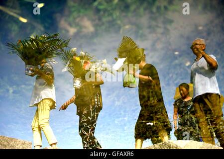 Beijing, China's Hebei Province. 28th July, 2016. Inverted reflection shows people mourning for relatives killed in the 1976 Tangshan earthquake in front of a memorial wall in Tangshan, north China's Hebei Province, July 28, 2016. © Wu Xiaoling/Xinhua/Alamy Live News Stock Photo